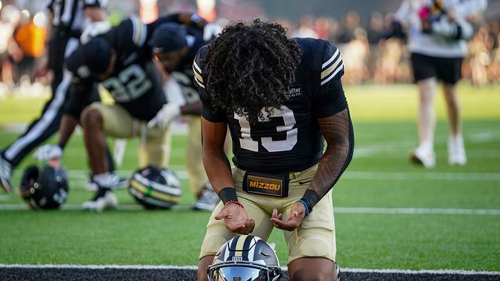 Sep 19, 2026; Columbia, Missouri, USA; Missouri Tigers quarterback Austin Simmons (13) kneels in the end zone prior to a game against the Troy Trojans at Faurot Field at Memorial Stadium. Mandatory Credit: Denny Medley-Imagn Images Sep 19, 2026; Columbia, Missouri, USA; Missouri Tigers quarterback Austin Simmons (13) kneels in the end zone prior to a game against the Troy Trojans at Faurot Field at Memorial Stadium. Mandatory Credit: Denny Medley-Imagn Images