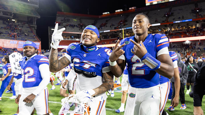 Oct 19, 2024; Gainesville, Florida, USA; Florida Gators defensive back Dijon Johnson (27) and Florida Gators quarterback DJ Lagway (2) gesture to a camera after a game against the Kentucky Wildcats at Ben Hill Griffin Stadium. Mandatory Credit: Matt Pendleton-Imagn Images