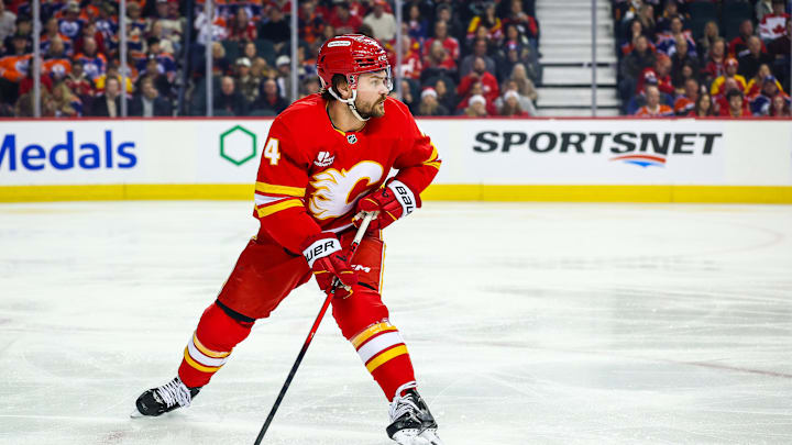 Dec 27, 2025; Calgary, Alberta, CAN; Calgary Flames defenseman Rasmus Andersson (4) controls the puck against the Edmonton Oilers during the first period at Scotiabank Saddledome. Mandatory Credit: Sergei Belski-Imagn Images
