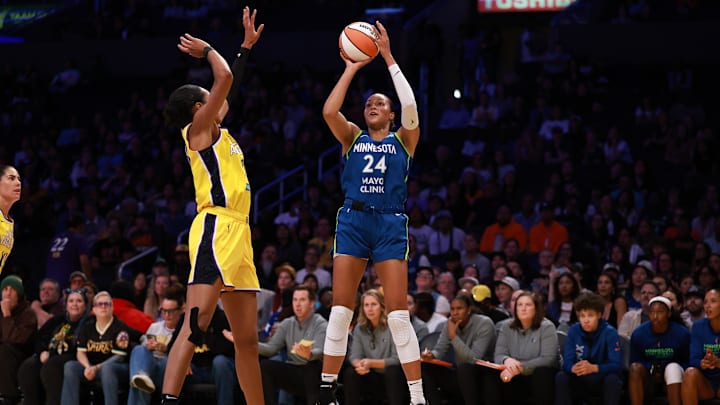 May 18, 2025; Los Angeles, California, USA;  Minnesota Lynx forward Napheesa Collier (24) shoots the ball over Los Angeles Sparks forward Azura Stevens (23) during the first quarter at Crypto.com Arena. Mandatory Credit: Kiyoshi Mio-Imagn Images