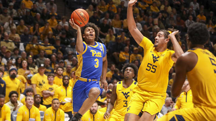 Nov 13, 2025; Morgantown, West Virginia, USA; Pittsburgh Panthers guard Brandin Cummings (3) shoots over West Virginia Mountaineers center Harlan Obioha (55) during the first half at WVU Coliseum. Mandatory Credit: Ben Queen-Imagn Images