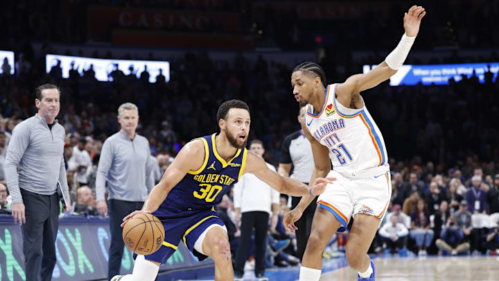 Dec 8, 2023; Oklahoma City, Oklahoma, USA; Golden State Warriors guard Stephen Curry (30) drives around Oklahoma City Thunder guard Aaron Wiggins (21) during overtime at Paycom Center. Mandatory Credit: Alonzo Adams-Imagn Images Dec 8, 2023; Oklahoma City, Oklahoma, USA; Golden State Warriors guard Stephen Curry (30) drives around Oklahoma City Thunder guard Aaron Wiggins (21) during overtime at Paycom Center. Mandatory Credit: Alonzo Adams-Imagn Images