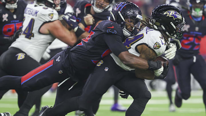 Dec 25, 2024; Houston, Texas, USA;  Houston Texans defensive end Dylan Horton (92) attempts to tackle Baltimore Ravens running back Keaton Mitchell (34) during the fourth quarter at NRG Stadium. Mandatory Credit: Troy Taormina-Imagn Images