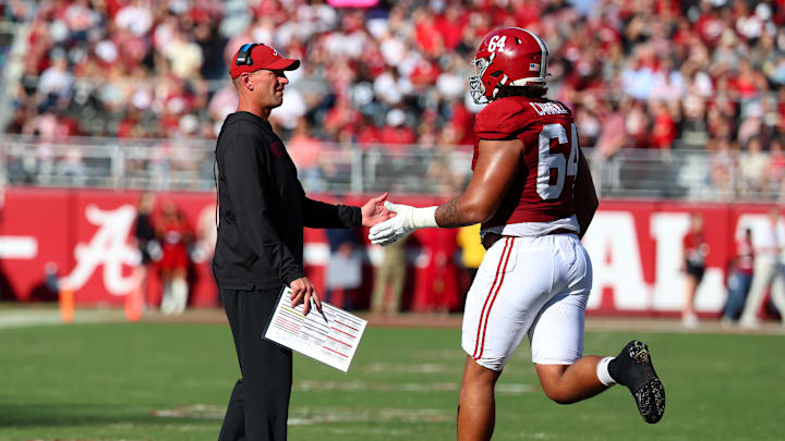 Nov 22, 2025; Tuscaloosa, Alabama, USA; Alabama Crimson Tide head coach Kalen DeBoer high fives Alabama Crimson Tide offensive lineman Michael Carroll (64) during the first half against the Eastern Illinois Panthers at Saban Field at Bryant-Denny Stadium. Mandatory Credit: David Leong-Imagn Images