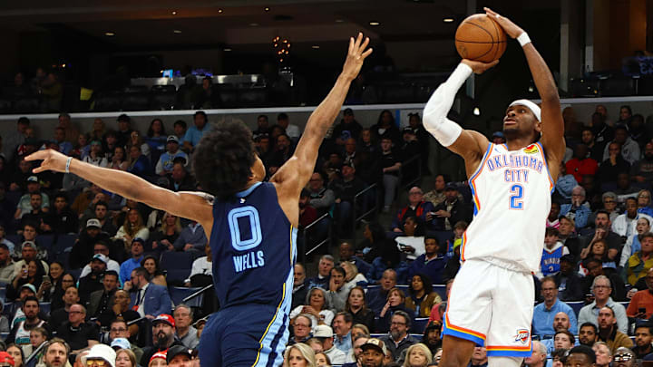 Mar 5, 2025; Memphis, Tennessee, USA; Oklahoma City Thunder guard Shai Gilgeous-Alexander (2) shoots as Memphis Grizzlies forward Jaylen Wells (0) defends during the second quarter at FedExForum. Mandatory Credit: Petre Thomas-Imagn Images