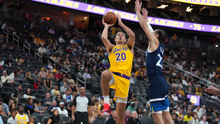 Oct 6, 2022; Las Vegas, Nevada, USA; Los Angeles Lakers forward Cole Swider (20) shoots against Minnesota Timberwolves guard CJ Elleby (22) during a preseason game at T-Mobile Arena. Mandatory Credit: Stephen R. Sylvanie-Imagn Images