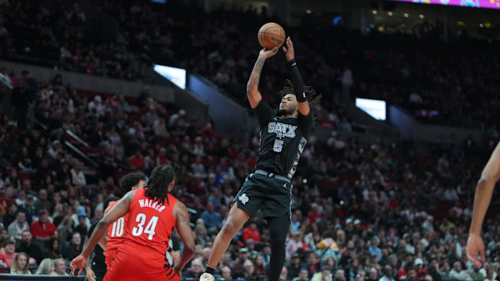Apr 6, 2025; Portland, Oregon, USA; San Antonio Spurs guard Stephon Castle (5) shoots over Portland Trail Blazers forward Jabari Walker (34) during the first half at Moda Center. Mandatory Credit: Soobum Im-Imagn Images