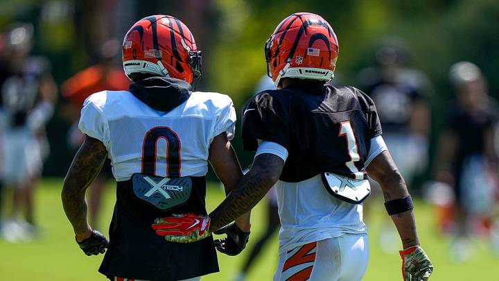 Cincinnati Bengals cornerback DJ Turner II (0) walks off wide receiver Ja'marr Chase (1) after Chase was injured in a collision between the two during Bengals training camp practice at the Paycor Stadium practice facility in downtown Cincinnati on Tuesday, Aug. 25, 2026. Cincinnati Bengals cornerback DJ Turner II (0) walks off wide receiver Ja'marr Chase (1) after Chase was injured in a collision between the two during Bengals training camp practice at the Paycor Stadium practice facility in downtown Cincinnati on Tuesday, Aug. 25, 2026.