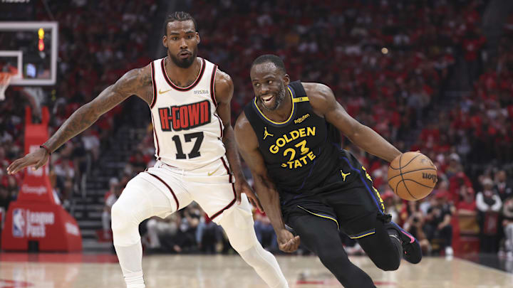 May 4, 2025; Houston, Texas, USA; Golden State Warriors forward Draymond Green (23) drives with the ball past Houston Rockets forward Tari Eason (17) to score a basket during the second quarter of game seven of first round for the 2025 NBA Playoffs at Toyota Center. Mandatory Credit: Troy Taormina-Imagn Images