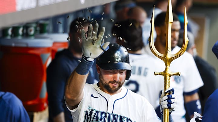 Jun 30, 2025; Seattle, Washington, USA; Seattle Mariners catcher Cal Raleigh (29) swats away sunflower seeds thrown by a teammate
