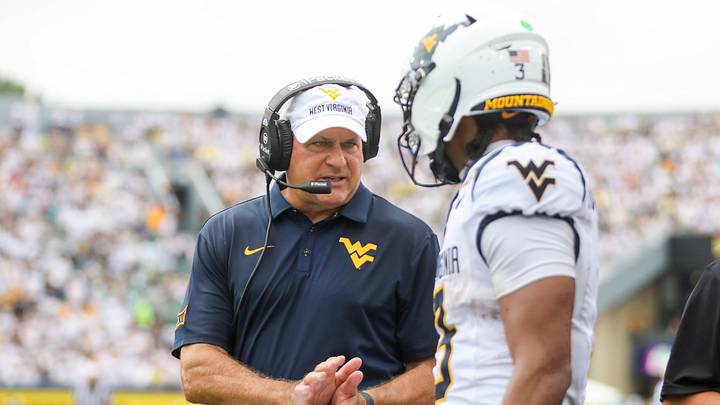 Sep 5, 2026; Morgantown, West Virginia, USA; West Virginia Mountaineers head coach Rich Rodriguez talks with West Virginia Mountaineers quarterback Michael Hawkins Jr. (3) before an offensive possession during the second quarter against the Coastal Carolina Chanticleers at Milan Puskar Stadium. Mandatory Credit: Ben Queen-Imagn Images Sep 5, 2026; Morgantown, West Virginia, USA; West Virginia Mountaineers head coach Rich Rodriguez talks with West Virginia Mountaineers quarterback Michael Hawkins Jr. (3) before an offensive possession during the second quarter against the Coastal Carolina Chanticleers at Milan Puskar Stadium. Mandatory Credit: Ben Queen-Imagn Images