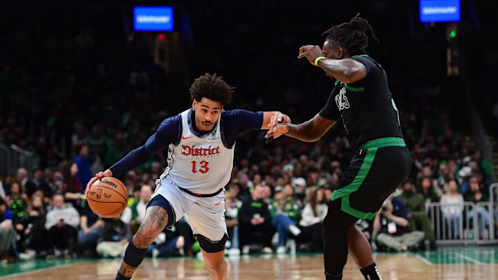 Apr 6, 2025; Boston, Massachusetts, USA; Washington Wizards guard Jordan Poole (13) controls the ball while Boston Celtics guard Jrue Holiday (4) defends during the first half at TD Garden. Mandatory Credit: Bob DeChiara-Imagn Images