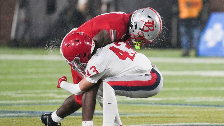 Rain flies off Baylor's David Gabriel Georges (0) and Brentwood Academy's Hill Strong (43) as they make contact during the Division II-AAA Championship match between Baylor versus. Brentwood Academy in Finley Stadium, Chattanooga, Tenn., on Thursday, Dec. 4, 2025.