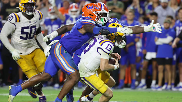 Florida Gators linebacker Shemar James (6) and defensive lineman Caleb Banks sack LSU Tigers quarterback Garrett Nussmeier.