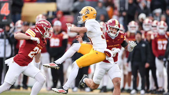 Nov 1, 2025; Ames, Iowa, USA; Arizona State Sun Devils punter Kanyon Floyd (31)is pressured by Iowa State Cyclones linebacker Will McLaughlin (23) and linebacker Cael Brezina (9) during the second half at Jack Trice Stadium. Mandatory Credit: Reese Strickland-Imagn Images