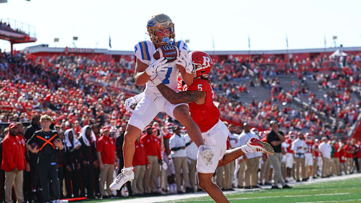 Oct 19, 2024; Piscataway, New Jersey, USA; UCLA Bruins wide receiver Logan Loya (17) catches a touchdown pass as Rutgers Scarlet Knights defensive back Kaj Sanders (5) defends during the first half at SHI Stadium. Mandatory Credit: Vincent Carchietta-Imagn Images