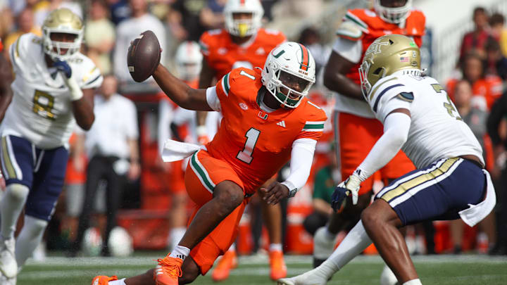 Nov 9, 2024; Atlanta, Georgia, USA; Miami Hurricanes quarterback Cam Ward (1) scrambles against the Georgia Tech Yellow Jackets in the second quarter at Bobby Dodd Stadium at Hyundai Field. Mandatory Credit: Brett Davis-Imagn Images