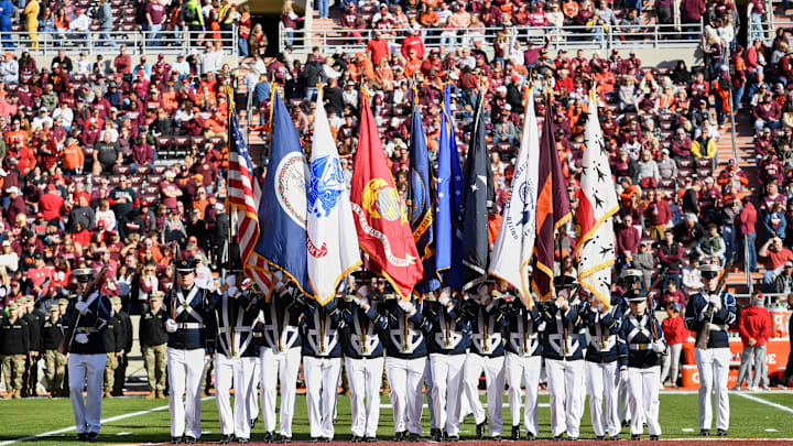 Nov 1, 2025; Blacksburg, Virginia, USA;  The Virginia Tech Hokies corps of cadets stand on the field with flags before the game against the Louisville Cardinals at Lane Stadium. Mandatory Credit: Brian Bishop-Imagn Images