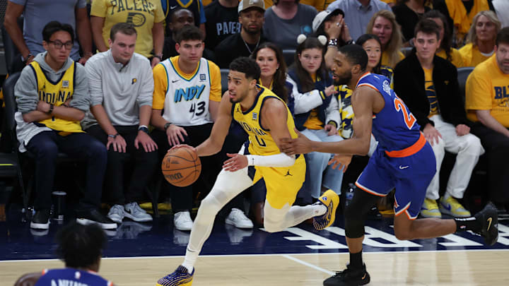 May 31, 2025; Indianapolis, Indiana, USA; Indiana Pacers guard Tyrese Haliburton (0) dribbles the ball defended by New York Knicks forward Mikal Bridges (25) in the fourth quarter during game six of the eastern conference finals for the 2025 NBA Playoffs at Gainbridge Fieldhouse. Mandatory Credit: Trevor Ruszkowski-Imagn Images