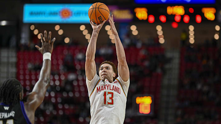 Feb 21, 2026; College Park, Maryland, USA; Maryland Terrapins forward Elijah Saunders (13) shoots over the reach of Washington Huskies center Franck Kepnang (11) during the second half at Xfinity Center. Mandatory Credit: Tommy Gilligan-Imagn Images Feb 21, 2026; College Park, Maryland, USA; Maryland Terrapins forward Elijah Saunders (13) shoots over the reach of Washington Huskies center Franck Kepnang (11) during the second half at Xfinity Center. Mandatory Credit: Tommy Gilligan-Imagn Images