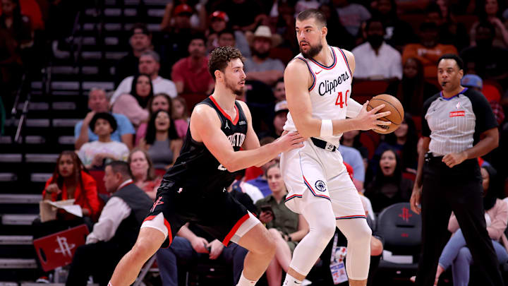 Nov 13, 2024; Houston, Texas, USA; LA Clippers center Ivica Zubac (40) handles the ball against Houston Rockets center Alperen Sengun (28) during the third quarter at Toyota Center. Mandatory Credit: Erik Williams-Imagn Images