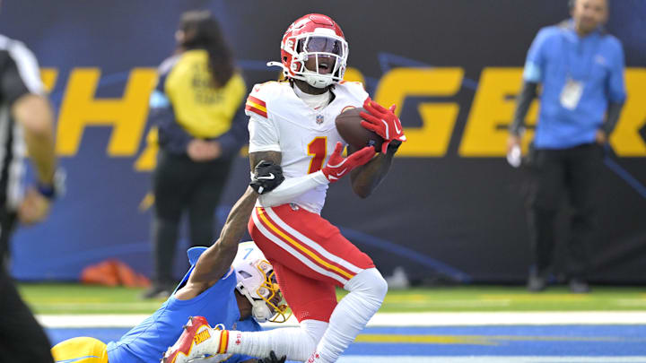 Sep 29, 2024; Inglewood, California, USA;  Kansas City Chiefs wide receiver Xavier Worthy (1) is defended by Los Angeles Chargers cornerback Kristian Fulton (7) as he hangs on to a touchdown pass in the first half at SoFi Stadium. Mandatory Credit: Jayne Kamin-Oncea-Imagn Images