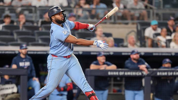 May 20, 2026; Bronx, New York, USA; Toronto Blue Jays first baseman Vladimir Guerrero Jr. (27) hits an RBI sacrifice fly during the seventh inning against the New York Yankees at Yankee Stadium. Mandatory Credit: Vincent Carchietta-Imagn Images