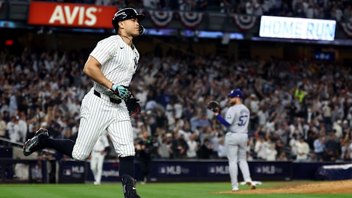Oct 30, 2024; New York, New York, USA; New York Yankees designated hitter Giancarlo Stanton (27) reacts after hitting a home run against Los Angeles Dodgers pitcher Ryan Brasier (57) during the third inning in game five of the 2024 MLB World Series at Yankee Stadium. Mandatory Credit: Vincent Carchietta-Imagn Images