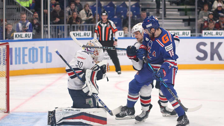 Ilya Nabokov (30) of Metallurg and Pavel Akolzin (18) of SKA...