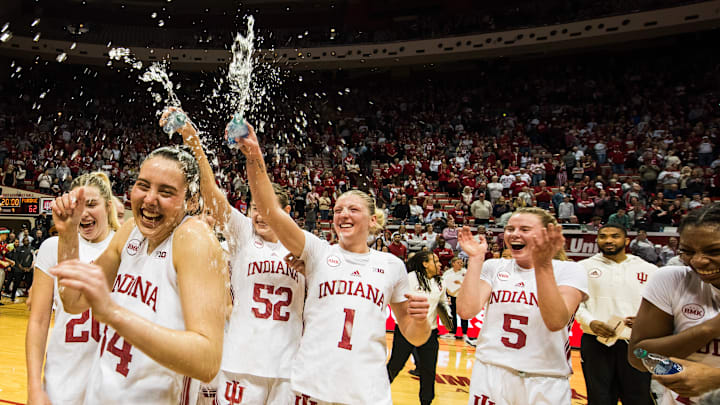 Teammates celebrate after Mackenzie Holmes made history as...