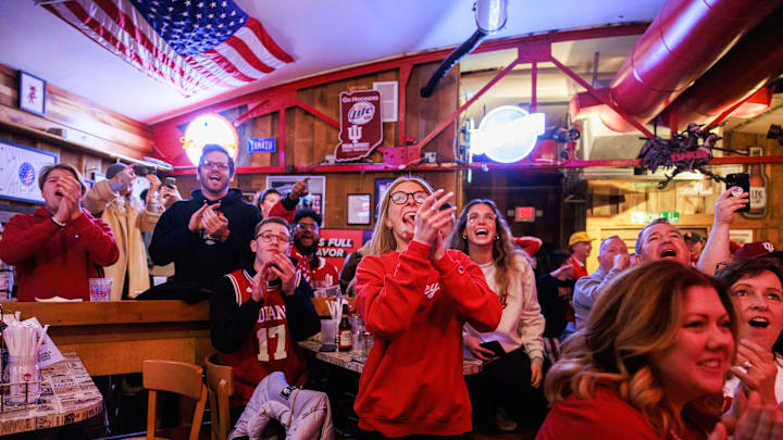 Indiana University basketball fans cheer as the Hoosiers...