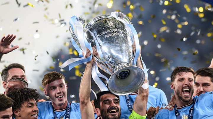 Ilkay Gundogan (C) of Manchester City FC lifts the trophy as...