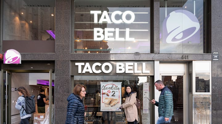 Pedestrians walk past the American chain of fast-food...