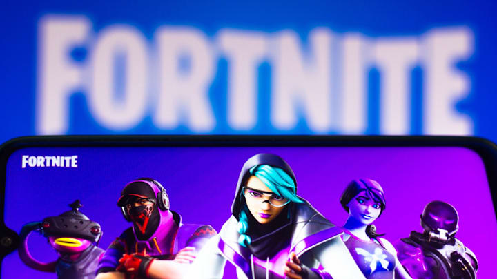 In this photo illustration the Fortnite logo is seen on a...