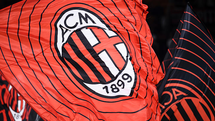 A flag bearing the crest of AC Milan is waved during the...