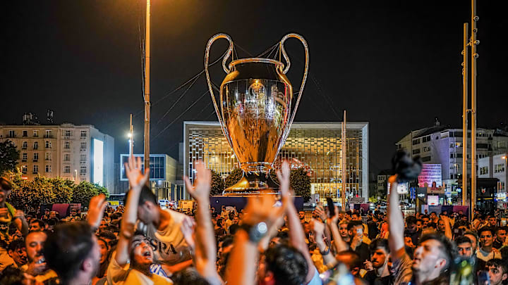 Manchester City fans celebrate in front of the giant...