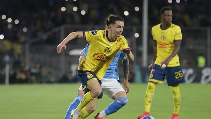 Alvaro Fidalgo #8 of America drives the ball forward during...