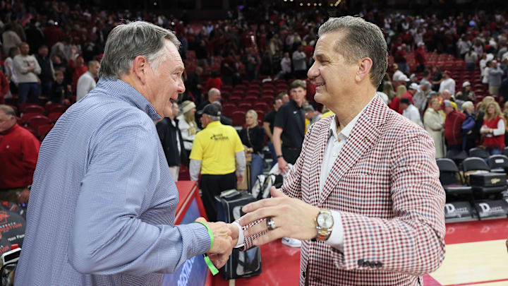 Feb 21, 2026; Fayetteville, Arkansas, USA; Former Arkansas Razorbacks head football coach Houston Nutt shakes hands with head basketball coach John Calipari after the game against the Missouri Tigers at Bud Walton Arena. Arkansas won 94-86. Mandatory Credit: Nelson Chenault-Imagn Images Feb 21, 2026; Fayetteville, Arkansas, USA; Former Arkansas Razorbacks head football coach Houston Nutt shakes hands with head basketball coach John Calipari after the game against the Missouri Tigers at Bud Walton Arena. Arkansas won 94-86. Mandatory Credit: Nelson Chenault-Imagn Images