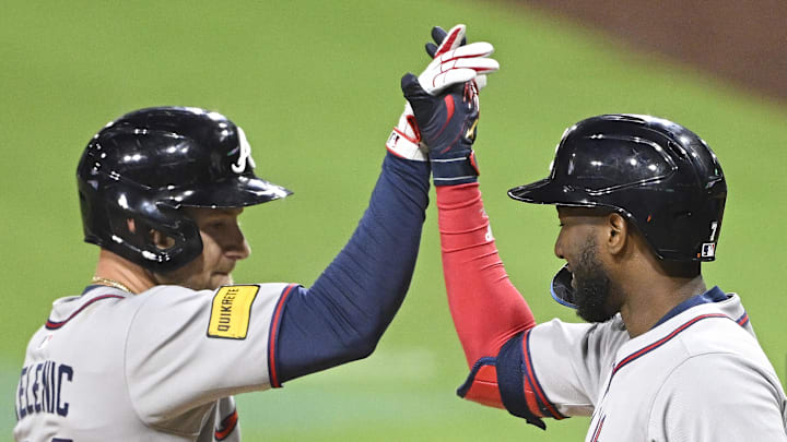Mar 28, 2025; San Diego, California, USA; Atlanta Braves left fielder Jarred Kelenic (24), left, is congratulated by  Jurickson Profar (7) after hitting a solo home run during fifth inning against the San Diego Padres at Petco Park. Mandatory Credit: Denis Poroy-Imagn Images