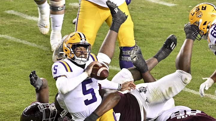 Nov 26, 2022; College Station, Texas, USA;  Texas A&M Aggies defensive lineman Shemar Turner (5) and defensive lineman McKinnley Jackson (35) sack LSU Tigers quarterback Jayden Daniels (5) during the fourth quarter at Kyle Field. Mandatory Credit: Maria Lysaker-Imagn Images