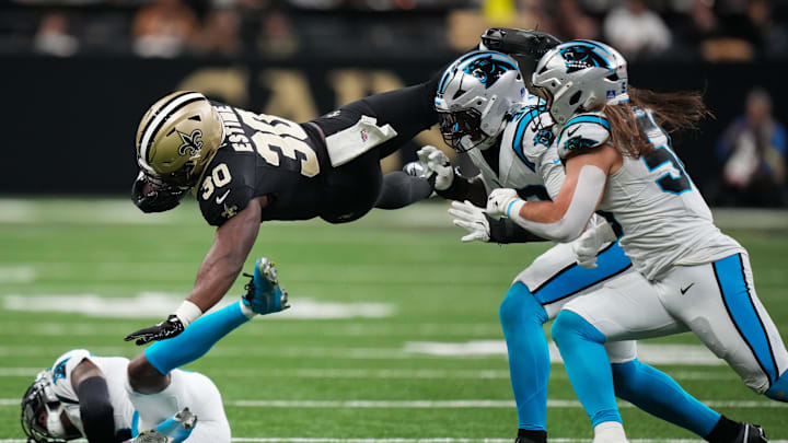 Dec 14, 2025; New Orleans, Louisiana, USA; New Orleans Saints running back Audric Estime (30) leaps over Carolina Panthers cornerback Jaycee Horn (8) during the second quarter at Caesars Superdome. Mandatory Credit: Matthew Hinton-Imagn Images Dec 14, 2025; New Orleans, Louisiana, USA; New Orleans Saints running back Audric Estime (30) leaps over Carolina Panthers cornerback Jaycee Horn (8) during the second quarter at Caesars Superdome. Mandatory Credit: Matthew Hinton-Imagn Images