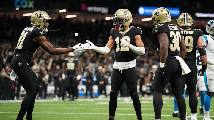 Dec 14, 2025; New Orleans, Louisiana, USA; New Orleans Saints wide receiver Chris Olave (12) celebrates with wide receiver Kevin Austin Jr. (81) teammates after scoring a touchdown in the fourth quarter against the Carolina Panthers at Caesars Superdome. Mandatory Credit: Matthew Hinton-Imagn Images Dec 14, 2025; New Orleans, Louisiana, USA; New Orleans Saints wide receiver Chris Olave (12) celebrates with wide receiver Kevin Austin Jr. (81) teammates after scoring a touchdown in the fourth quarter against the Carolina Panthers at Caesars Superdome. Mandatory Credit: Matthew Hinton-Imagn Images