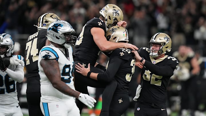 Dec 14, 2025; New Orleans, Louisiana, USA; New Orleans Saints place kicker Charlie Smyth (39) celebrates with punter Kai Kroeger (32) after kicking the game winning field goal for a 20-17 win over the Carolina Panthers in the fourth quarter at Caesars Superdome. Mandatory Credit: Matthew Hinton-Imagn Images Dec 14, 2025; New Orleans, Louisiana, USA; New Orleans Saints place kicker Charlie Smyth (39) celebrates with punter Kai Kroeger (32) after kicking the game winning field goal for a 20-17 win over the Carolina Panthers in the fourth quarter at Caesars Superdome. Mandatory Credit: Matthew Hinton-Imagn Images