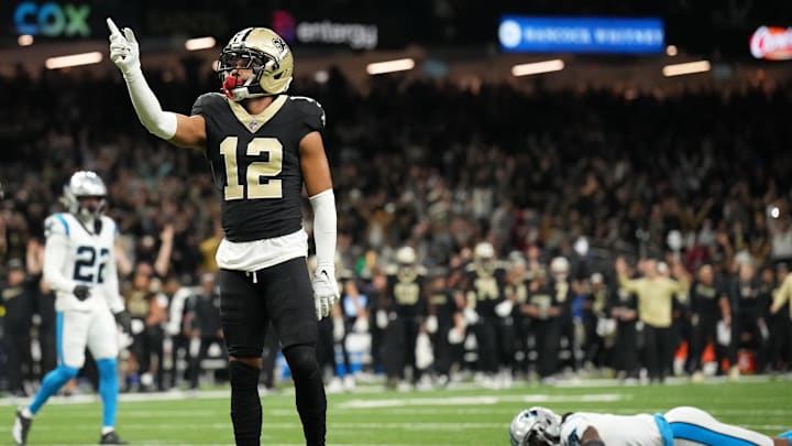Dec 14, 2025; New Orleans, Louisiana, USA; New Orleans Saints wide receiver Chris Olave (12) reacts after scoring a touchdown in the fourth quarter against the Carolina Panthers at Caesars Superdome. Mandatory Credit: Matthew Hinton-Imagn Images
