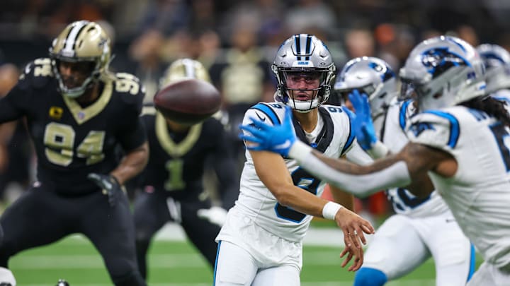 Carolina Panthers quarterback Bryce Young (9) passes the ball to Carolina Panthers running back Rico Dowdle 