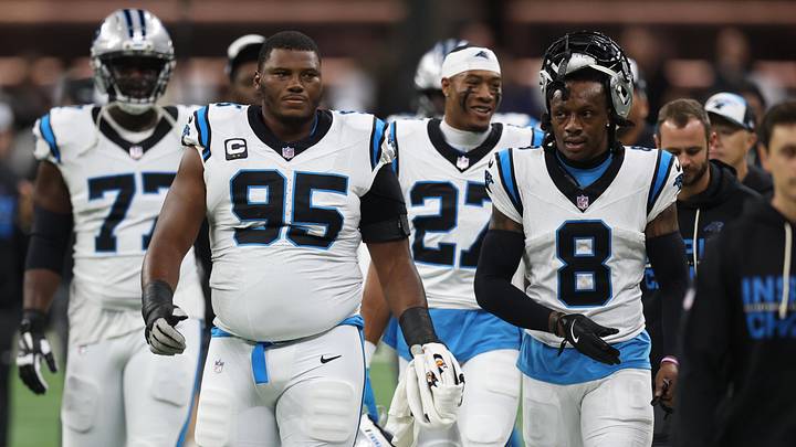 Carolina Panthers defensive end Derrick Brown (95) and cornerback Jaycee Horn (8) walk on the field 