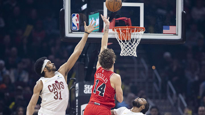 Dec 19, 2025; Cleveland, Ohio, USA; Chicago Bulls forward Matas Buzelis (14) makes a shot past Cleveland Cavaliers center Jarrett Allen (31) and guard Darius Garland (10) during the first quarter at Rocket Arena. Mandatory Credit: Scott Galvin-Imagn Images