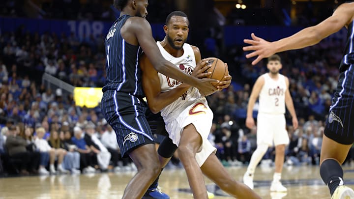 Feb 25, 2025; Orlando, Florida, USA;  Cleveland Cavaliers forward Evan Mobley (4) tries to drive to the basket as Orlando Magic forward Jonathan Isaac (1) defends in the second half at Kia Center. Mandatory Credit: Russell Lansford-Imagn Images