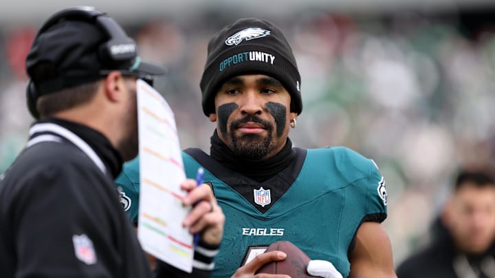 Dec 14, 2025; Philadelphia, Pennsylvania, USA; Philadelphia Eagles quarterback Jalen Hurts (1) speaks with offensive coordinator Kevin Patullo (left) during the first quarter against the Las Vegas Raiders before taking a possession at Lincoln Financial Field. 