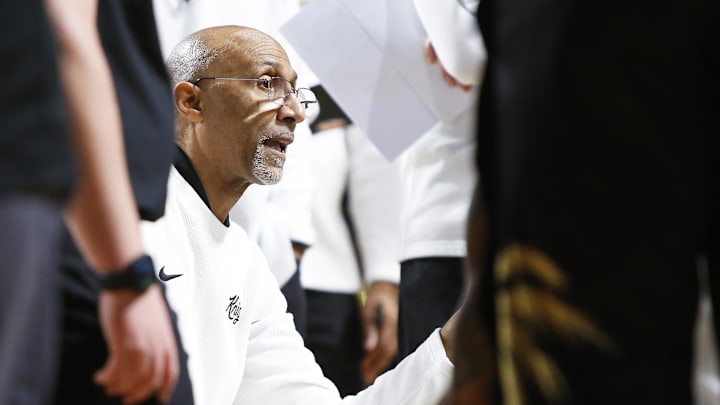 Feb 23, 2025; Orlando, Florida, USA; Central Florida Knights head coach Johnny Dawkins talks with his players during a timeout against the Utah Utes at Addition Financial Arena. Mandatory Credit: Russell Lansford-Imagn Images